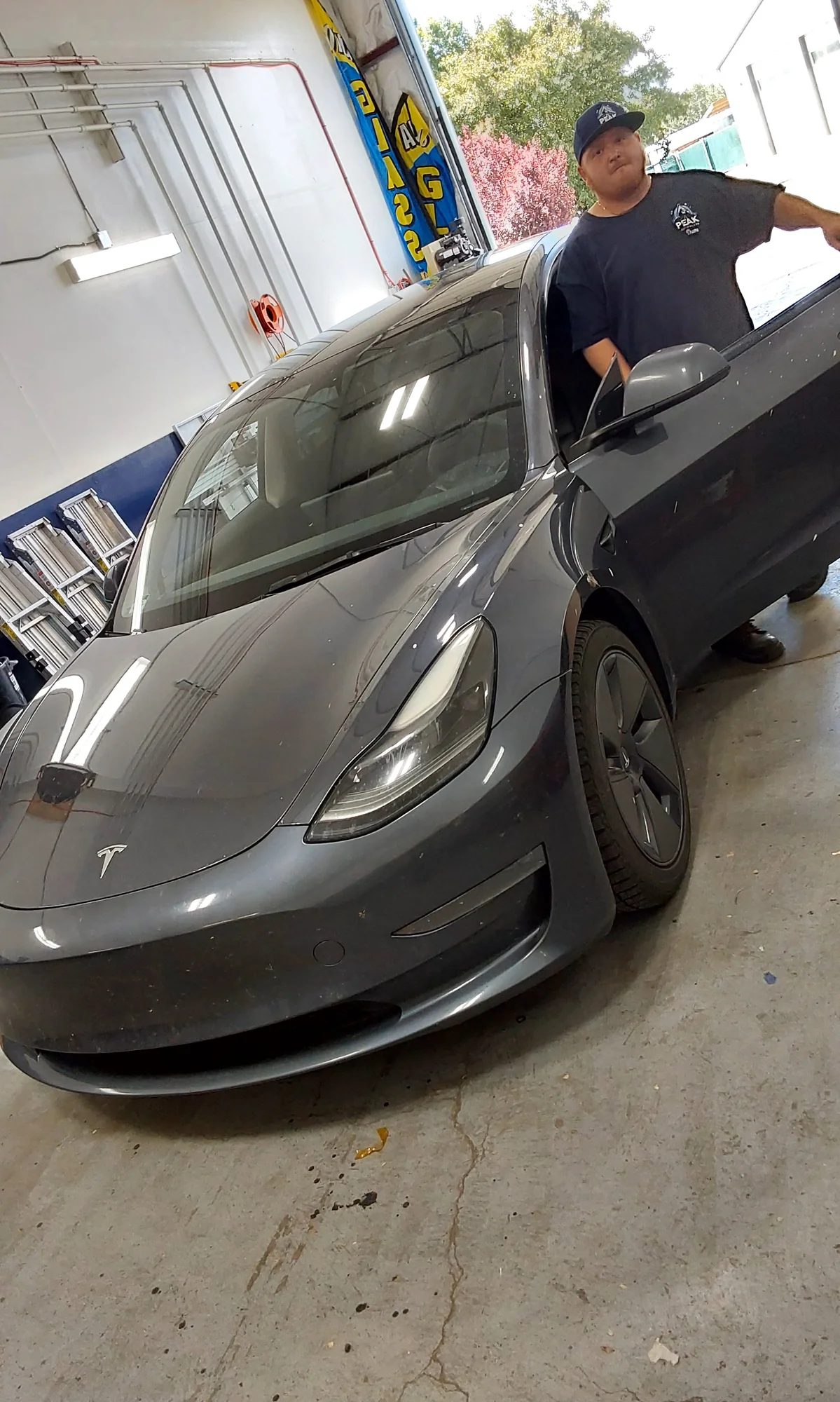 Peak Auto Glass technician with a Tesla Model 3